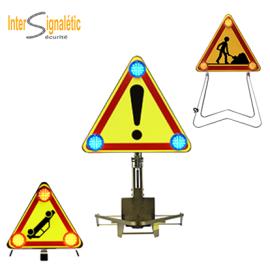 Ground-mounted warning triangle with 3 flashing lights to indicate a danger zone or work area.